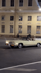 Classic convertibles out on city streets after dark