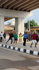 Outdoor group exercise class under a Jos overpass