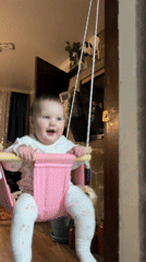 Two babies play on carpet in Novopokrovskaya home