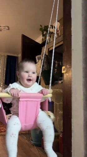 Two babies play on carpet in Novopokrovskaya home