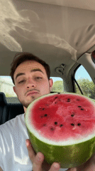 Man displays fresh watermelon from car in Mexico