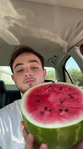 Man displays fresh watermelon from car in Mexico