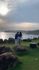Couples pose for photos at scenic Mirissa coastline overlook