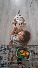 Morning domestic routine: child plays, adult makes juice in Kempelevo