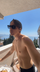 Man enjoys sunny balcony view in Montenegro coastal town