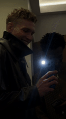 Two men take mirror selfies in London building