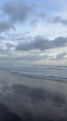 Beach sunset documented through changing skies and gentle waves