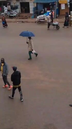 Rainy afternoon street life and market activity in Bukuru, Nigeria