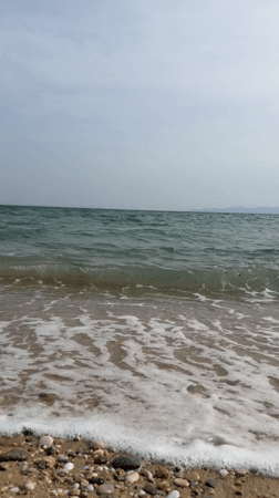 Overcast afternoon documented at quiet Greek beach