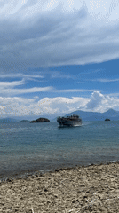 Ferry crosses clear waters near Fethiye under cloudy skies
