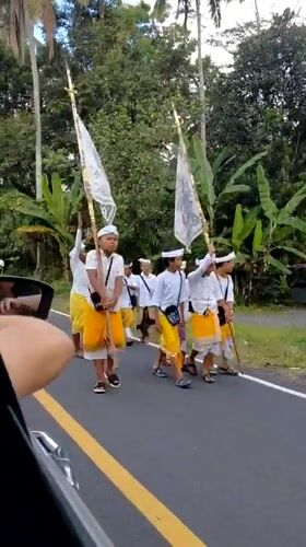 Traditional Balinese procession through the streets of Tampaksiring
