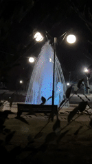Summer night in Gornyy: fountains, buildings, and a foraging hedgehog