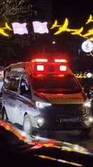Emergency vehicle rushes through Nha Trang night traffic