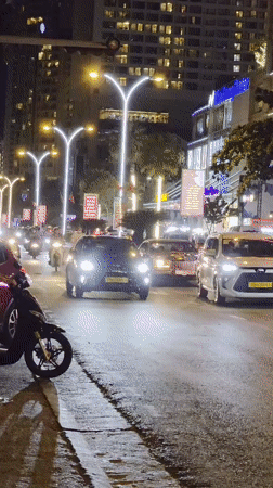 Emergency vehicle rushes through Nha Trang night traffic