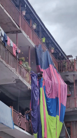 Vashisht market street alive with vendors, fabric, and foot traffic