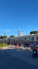 Railroad crossing stop near Đà Nẵng's landmarks, June 2026