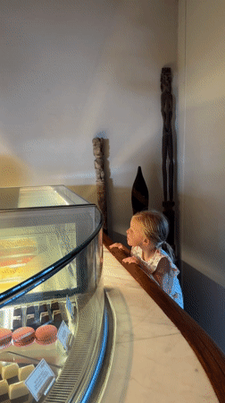Girl and woman browse bakery display cases in Kuta Selatan