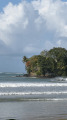 Weligama's rocky coast, surf, and beached fishing boats