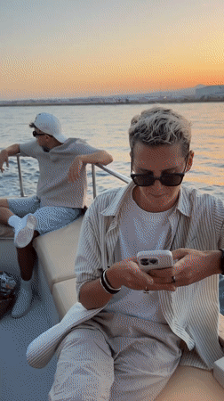 Boat passengers photograph planes and sunset near Larnaca airport