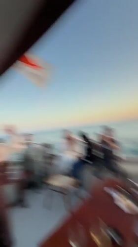 Boat passengers photograph planes and sunset near Larnaca airport