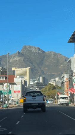 Morning rush hour traffic flows beneath Table Mountain