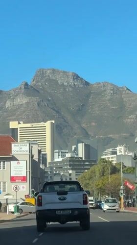 Morning rush hour traffic flows beneath Table Mountain