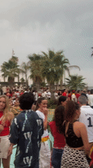Barcelona crowd gathers for outdoor sports watch party in red and yellow