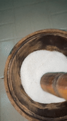 Food preparation using traditional mortar and pestle in Nigeria