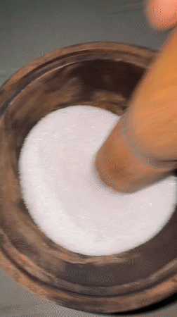 Food preparation using traditional mortar and pestle in Nigeria