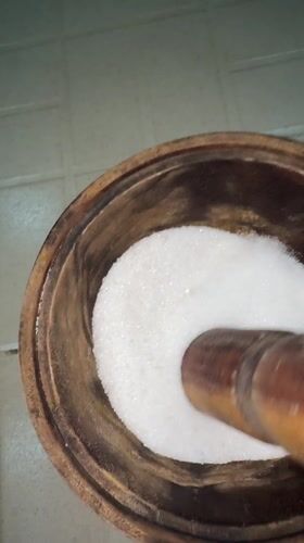 Food preparation using traditional mortar and pestle in Nigeria