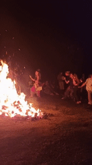 Nighttime bonfire gathering with dancing and drums in Izky, Ukraine