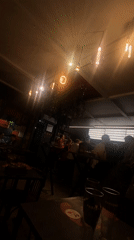 Evening social gathering captured at busy neighborhood bar