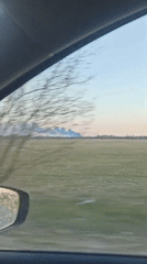 Vehicle occupant records green field with distant plumes near Кондратово