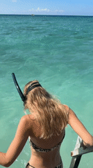 Woman enjoys morning beach activities at Indonesian seaside resort