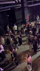 Young crowd gathers at Moscow nightclub with Russian flags