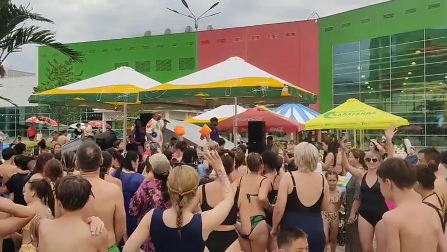 Swimwear crowd gathers for live performance at Almaty water event