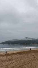 Overcast evening beach life captured in M'Diq, Morocco
