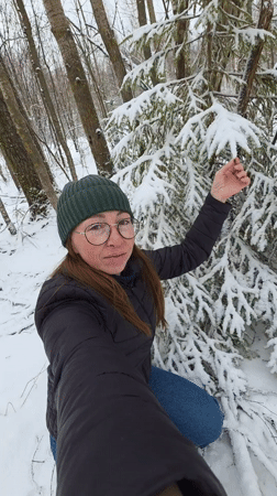 Woman films winter selfies in Russian forest near Kamennyi Kliuch