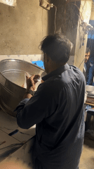 Man pours yellow liquid into steel container in Quetta