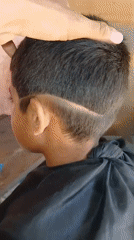 Child gets haircut in Porlamar, Venezuela