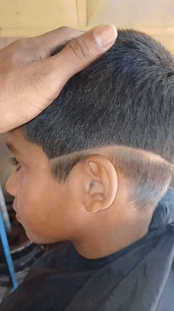 Child gets haircut in Porlamar, Venezuela