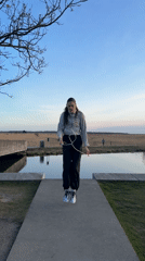 Woman jump ropes in Copenhagen park on sunny afternoon