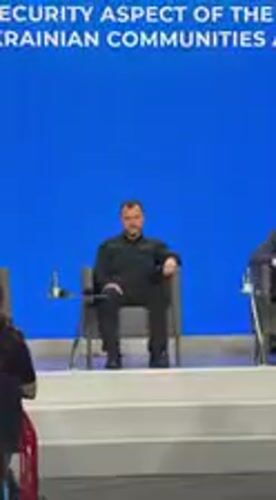 Conference panel discussion held in Kyiv featuring bearded speaker