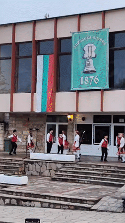 Traditional folk dance performance captured in Bulgarian hillside town