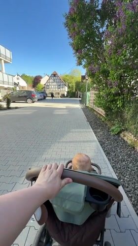 Parent with stroller spotted in Meisenheim during sunny afternoon