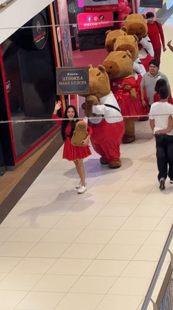 Costumed procession walks through commercial space in Peru