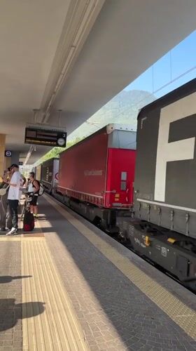 Morning platforms at Trento station, trains and passengers in motion