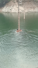 Young swimmers climb concrete pillars in Tinaquillo lake