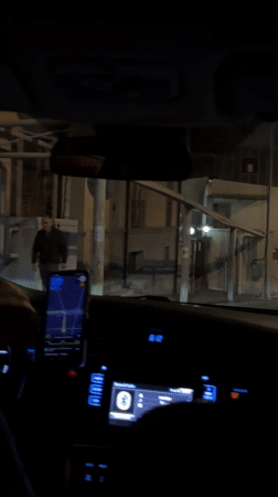 Driver navigates Yerevan streets at night using smartphone GPS