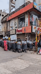School procession passes elephant statue on Bengaluru street